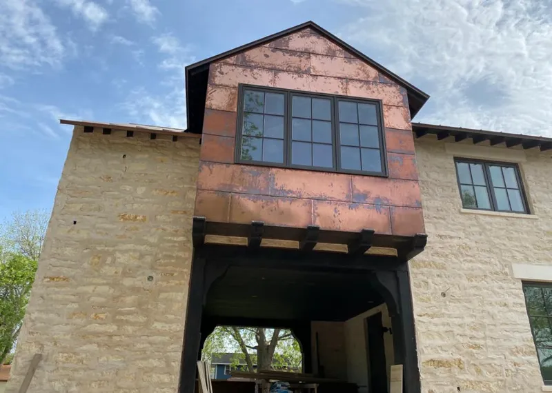 Copper metal panel facade on a stone building for Metal Roof Coating in Huntsville